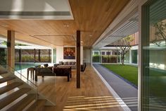 the inside of a modern house with wood floors and glass railings on both sides