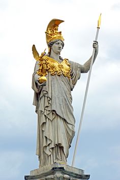 the statue is holding a golden staff