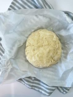 a doughnut sitting on top of a piece of wax paper in a wrapper