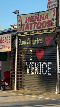 a couple of signs that are on the side of a store front door in an urban area