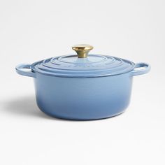 a blue casserole with a gold lid