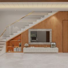 an empty living room with stairs leading up to the second floor and a television on top of a cabinet