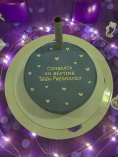 a birthday cake with congratulations written on the top and hearts around it, surrounded by confetti