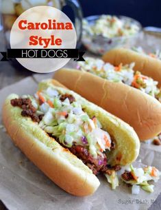 three hot dogs with cole slaw and chili on them