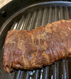 a piece of meat is cooking on a grill