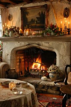 a living room filled with furniture and a fire place next to a table covered in flowers