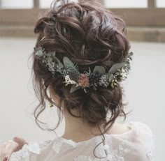 a woman wearing a flower crown in her hair