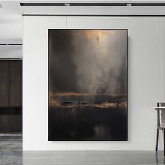 an abstract painting hangs on the wall above a dining room table and chairs in front of it