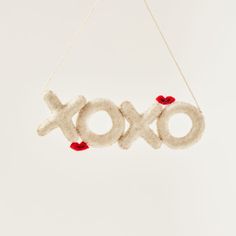 an ornament with the word xoxo hanging from it's side