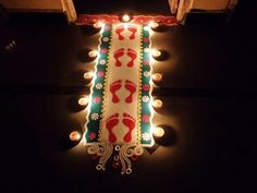 a lighted sign with footprints on it in the dark