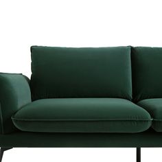 a green couch sitting on top of a wooden frame