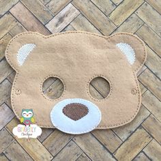 a brown teddy bear mask on a wooden floor