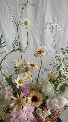 a vase filled with lots of different types of flowers