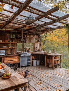 an outdoor kitchen on a wooden deck in the woods