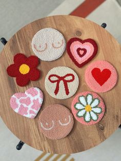 a wooden table topped with lots of different shaped magnets