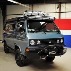 an old van is parked in a garage