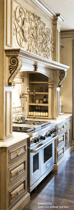 a large kitchen with an oven, stove and cabinets in the middle of it's wood flooring