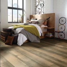 a bedroom with wood floors and white walls