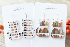 Bookshelf Cat Earrings or Mini Cat Face Earrings When you love cats but you also love books!  These cat earrings are perfect for the hard to buy person in your life! Choose either the bookshelf theme cat earrings or the mini cat face earrings in the drop down menu. Clear printed acrylic earrings on a stainless steel fishhook.  Each pair will be very similar to what is shown in the photos but will vary slightly in print.  Each earring is cut from a large sheet of printed acrylic so there will be some variance from pair to pair. Cat Bookshelf, Lover Earrings, Mom Earrings, Mini Cat, Face Earrings, When You Love, Cat Earrings, Earrings Statement, Cat Face