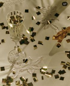 an image of a table setting with confetti and wineglasses on it