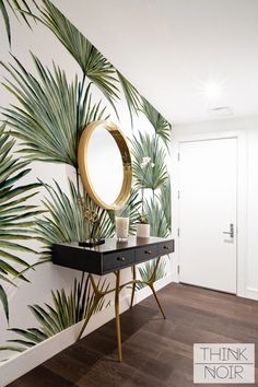 there is a mirror and some plants on the wall in this room with wood flooring