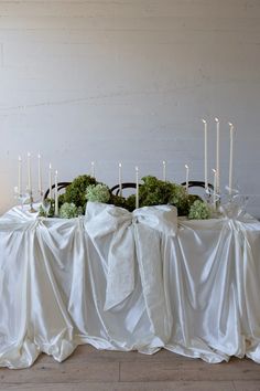 the table is covered with white cloth and candles