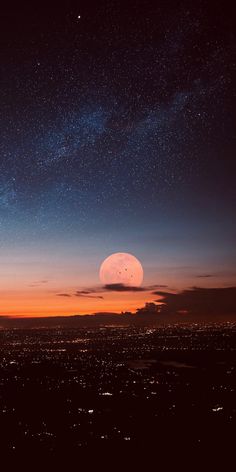 the night sky is filled with stars and bright orange hues as the moon rises in the distance