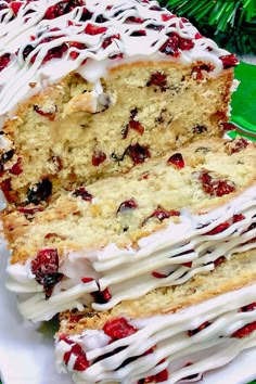 a cake with white frosting and cranberry toppings sitting on a plate