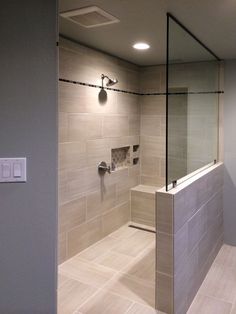 a walk in shower sitting inside of a bathroom