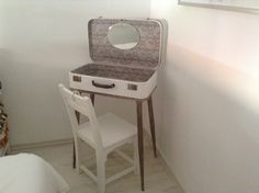 a white vanity table with a mirror and chair in front of it on the floor