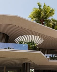 an architecturally designed building with palm trees in the background