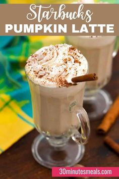 starbucks pumpkin latte with whipped cream and cinnamon on the rim in two clear mugs