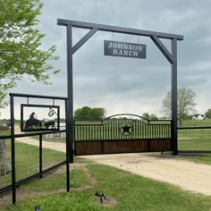 the entrance to john v ranch with a sign above it