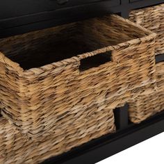 two wicker baskets are sitting on top of a black dresser with drawers and handles