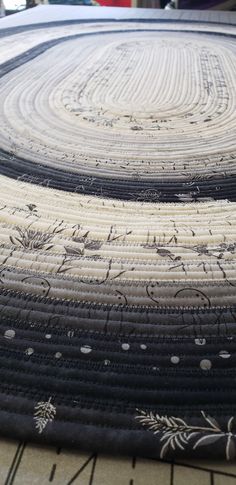 a close up of a circular rug on the ground