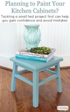 a blue stool with books on it and the title, planning to paint your kitchen cabinets? tack a small test project first can help you gain confidence and avoid