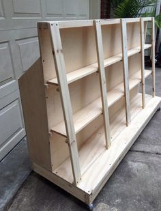 an unfinished bookcase sitting in front of a garage door