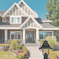 a house with a mailbox in front of it and landscaping around the entrance area