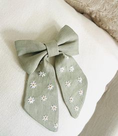 A Beautifully embroidered and delicate linen hair bow to use on a special occasion or simply to feel beautiful on any day. A very detailed, lightweight and perfectly finished hair accessory for any age.  Dimensios:   - Length: 19cm  - width (upper part): 12cm All products are carefully wrapped and packed in a beautiful gift box with a bow. Hair Bow Embroidery, Embroidered Hair Bow, Light Blue Bow Tie, Cottagecore Embroidery, Embroidered Hair Bows, Embroidered Bow, Hair Bow Clip, Blue Bow Tie, Bow Clip