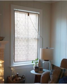 a living room filled with furniture and a fire place next to a window covered in blinds