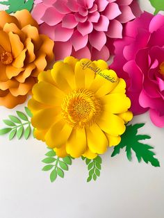 colorful paper flowers arranged on top of each other