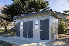 a couple of small restrooms sitting next to each other on the side of a road