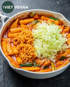 a pan filled with pasta and vegetables on top of a table