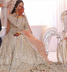 a woman in a wedding dress sitting on a couch