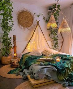 a bedroom with plants and lights on the wall, bedding is covered in blankets