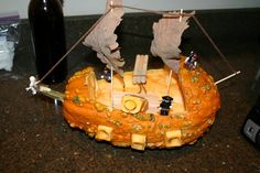 a pumpkin shaped like a pirate ship with sails and bones on it's side