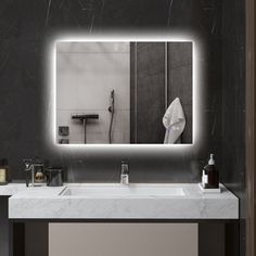 a bathroom sink with a lighted mirror above it