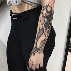 a woman with a tattoo on her arm