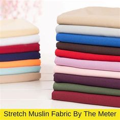 a stack of different colored fabrics sitting next to each other on top of a table