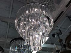 a chandelier hanging from the ceiling in a room with other lights and fixtures